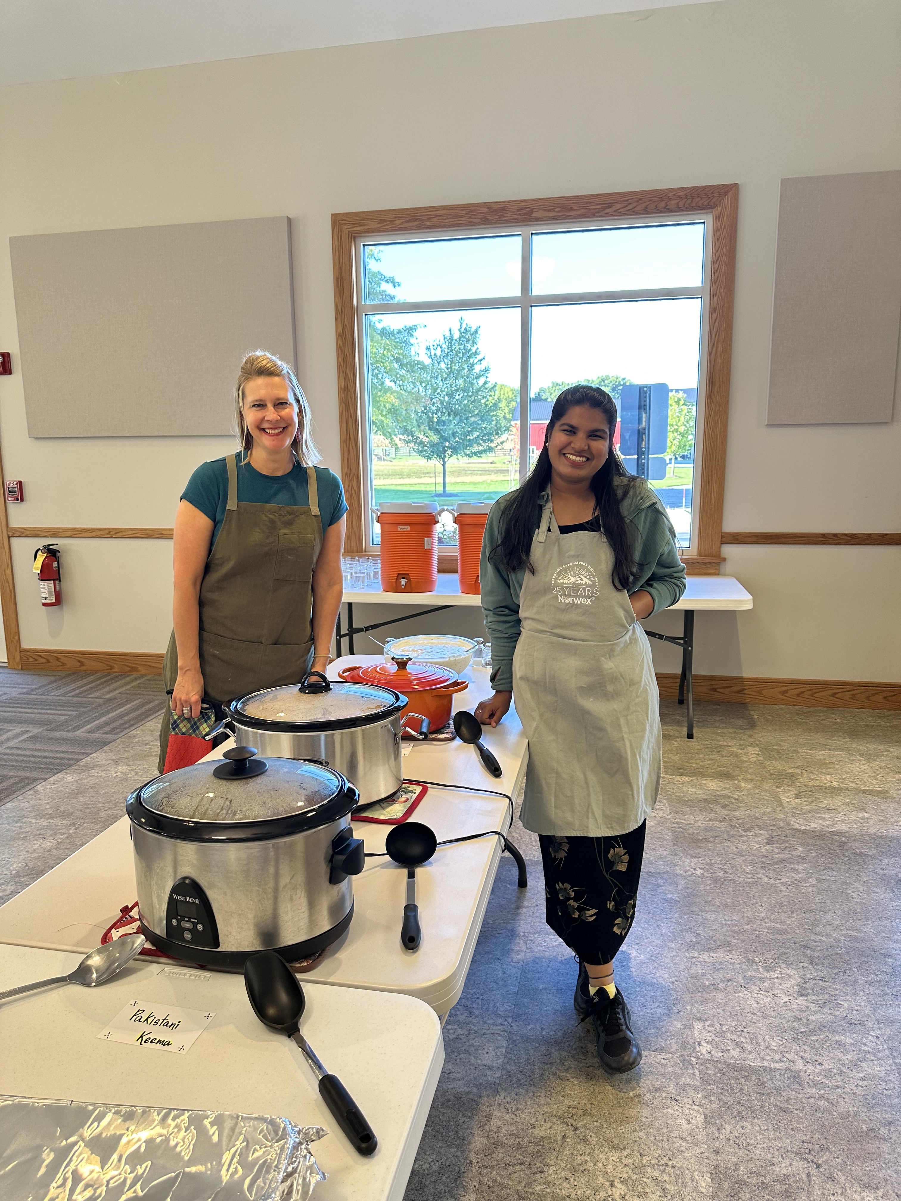 Two young women serving meals.